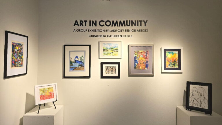 Several peices of art hanging on a wall from the Art in Community 2025 show